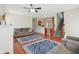 Open living room with hardwood floors, fireplace, adjacent kitchen, and staircase to the upper level at 13063 E 131St St, Fishers, IN 46037