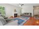 Cozy living room features a fireplace, hardwood floors, natural light, and comfortable seating at 13063 E 131St St, Fishers, IN 46037