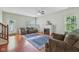 Comfortable living room with hardwood floors, fireplace, large windows, and natural light at 13063 E 131St St, Fishers, IN 46037