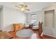 Sitting room features hardwood floors, ceiling fan, window, and comfy seating area at 13063 E 131St St, Fishers, IN 46037
