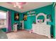 Bright bedroom with teal walls, carpet, and a white vanity at 13295 Patriotic Way, Fishers, IN 46037