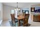 Bright dining area with a wooden table set for six, a chandelier, and access to the backyard at 13295 Patriotic Way, Fishers, IN 46037