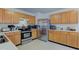 The kitchen features stainless steel appliances, light oak cabinets, and a functional layout for cooking and entertaining at 13295 Patriotic Way, Fishers, IN 46037