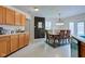 Eat-in kitchen with wooden cabinets, a chalkboard accent wall, and a dining table under a chandelier at 13295 Patriotic Way, Fishers, IN 46037