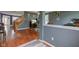 View of the living room featuring hardwood floors, a staircase, a TV, and comfortable seating arrangements at 13295 Patriotic Way, Fishers, IN 46037