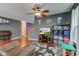 The living room has hardwood floors, a ceiling fan, a TV, and comfortable seating arrangements at 13295 Patriotic Way, Fishers, IN 46037