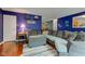 Comfortable living room with hardwood floors, a large sectional sofa, and a view of the staircase at 13295 Patriotic Way, Fishers, IN 46037