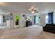 Large living room with a ceiling fan, entertainment center, and carpet flooring at 13295 Patriotic Way, Fishers, IN 46037