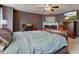 Spacious main bedroom with a fireplace, ceiling fan, TV, and a large wooden bed frame at 13295 Patriotic Way, Fishers, IN 46037