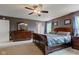 Main bedroom featuring dark gray walls, a wooden bed frame, and a dresser with a mirror at 13295 Patriotic Way, Fishers, IN 46037