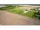 Aerial view of rural property with farmland and blue above-ground pool at 133 W Us Highway 52, Fountaintown, IN 46130