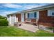 Relaxing back patio with seating, lush lawn, and brick exterior at 133 W Us Highway 52, Fountaintown, IN 46130