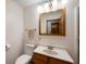 Bright bathroom featuring a single sink vanity and framed mirror at 133 W Us Highway 52, Fountaintown, IN 46130