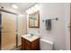 Bathroom featuring a glass-enclosed shower, oak vanity, and ample lighting at 133 W Us Highway 52, Fountaintown, IN 46130