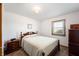 Bedroom with neutral carpet, vintage furniture, and a sunny window at 133 W Us Highway 52, Fountaintown, IN 46130