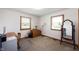 Bright bedroom with two windows, desk, and neutral carpet flooring at 133 W Us Highway 52, Fountaintown, IN 46130