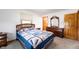 Comfortable bedroom with a cozy quilt, wood furniture, and bright window at 133 W Us Highway 52, Fountaintown, IN 46130