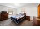 Bedroom featuring neutral carpet, wood furniture, and two bright windows at 133 W Us Highway 52, Fountaintown, IN 46130