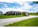 Ranch style home with brick facade, attached garage, large yard, and long gravel driveway at 133 W Us Highway 52, Fountaintown, IN 46130