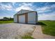 Spacious metal building with a large garage door, perfect for storage or workshop space at 133 W Us Highway 52, Fountaintown, IN 46130