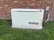 Guardian generator alongside brick wall, ensuring home power during outages at 133 W Us Highway 52, Fountaintown, IN 46130