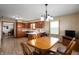 Eat in kitchen featuring wood cabinets, white countertops, a chandelier, and a view into the living room at 133 W Us Highway 52, Fountaintown, IN 46130