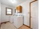 Bright laundry room featuring a washer, dryer, and ample cabinet space at 133 W Us Highway 52, Fountaintown, IN 46130