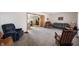 Spacious living room with carpet, comfortable seating, and connecting rooms at 133 W Us Highway 52, Fountaintown, IN 46130