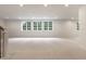 Large finished basement with recessed lighting and large windows overlooking a garden at 13309 Carmichael Ln, Carmel, IN 46074