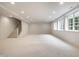 Spacious finished basement with stairs and natural light flooding in from the egress windows at 13309 Carmichael Ln, Carmel, IN 46074