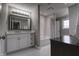Bright bathroom with a white vanity and a view to the bathtub shower combo at 13309 Carmichael Ln, Carmel, IN 46074