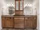 Bathroom featuring dual vanity sinks with wooden cabinets and granite countertops at 13309 Carmichael Ln, Carmel, IN 46074