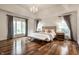 A spacious bedroom with natural lighting with neutral colors and wood floors at 13309 Carmichael Ln, Carmel, IN 46074