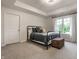 Bedroom boasts a door, a wrought-iron bed, and large windows overlooking the home's exterior at 13309 Carmichael Ln, Carmel, IN 46074