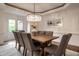 Dining room featuring a wooden table with fabric chairs and a crystal chandelier at 13309 Carmichael Ln, Carmel, IN 46074