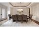 Bright dining room with chandelier and stylish chairs that complement the wood table at 13309 Carmichael Ln, Carmel, IN 46074