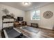 Home gym featuring modern exercise equipment and laminate wood flooring at 13309 Carmichael Ln, Carmel, IN 46074
