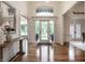 A foyer with hardwood floors, double french doors, large windows, and high ceilings at 13309 Carmichael Ln, Carmel, IN 46074