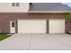 Attached three-car garage and side entry door with a concrete driveway at 13309 Carmichael Ln, Carmel, IN 46074