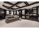 Luxury home theater in basement with comfortable seating and built in cabinetry at 13309 Carmichael Ln, Carmel, IN 46074