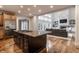 Open concept kitchen with granite countertops and stainless steel appliances that flows to living room at 13309 Carmichael Ln, Carmel, IN 46074