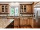 Kitchen with granite countertops, wooden cabinets, and stainless steel refrigerator at 13309 Carmichael Ln, Carmel, IN 46074