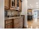 Kitchen area featuring dark wood cabinets, granite countertops, and stainless steel appliances at 13309 Carmichael Ln, Carmel, IN 46074