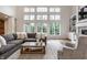 Spacious living room featuring hardwood floors, a fireplace and large windows at 13309 Carmichael Ln, Carmel, IN 46074