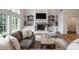 A living room with built in shelves, a fireplace and large windows at 13309 Carmichael Ln, Carmel, IN 46074