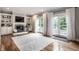 A sun filled living room featuring a cozy fireplace and walkout access to the outdoor at 13309 Carmichael Ln, Carmel, IN 46074