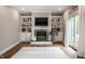 Living room with fireplace, built-in shelves, a TV and a sliding door to the backyard at 13309 Carmichael Ln, Carmel, IN 46074