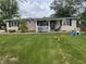 Charming single-story home featuring a well-maintained lawn, landscaping, and a welcoming front porch at 1505 Apple St, Greenfield, IN 46140
