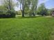 Spacious backyard with lush green grass and mature trees at 1515 Renee Dr, Plainfield, IN 46168