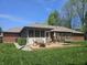 Backyard featuring a patio, screened porch, firepit and lush green lawn at 1515 Renee Dr, Plainfield, IN 46168